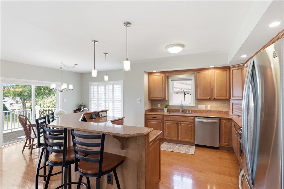 5791 Joy Road Conesus, NY 14435 - Photo 11 of 48 Chef’s kitchen with custom cabinetry, stainless steel appliances, and wraparound breakfast bar.
