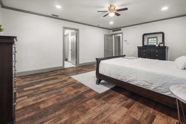 a bedroom with a large bed and a chandelier