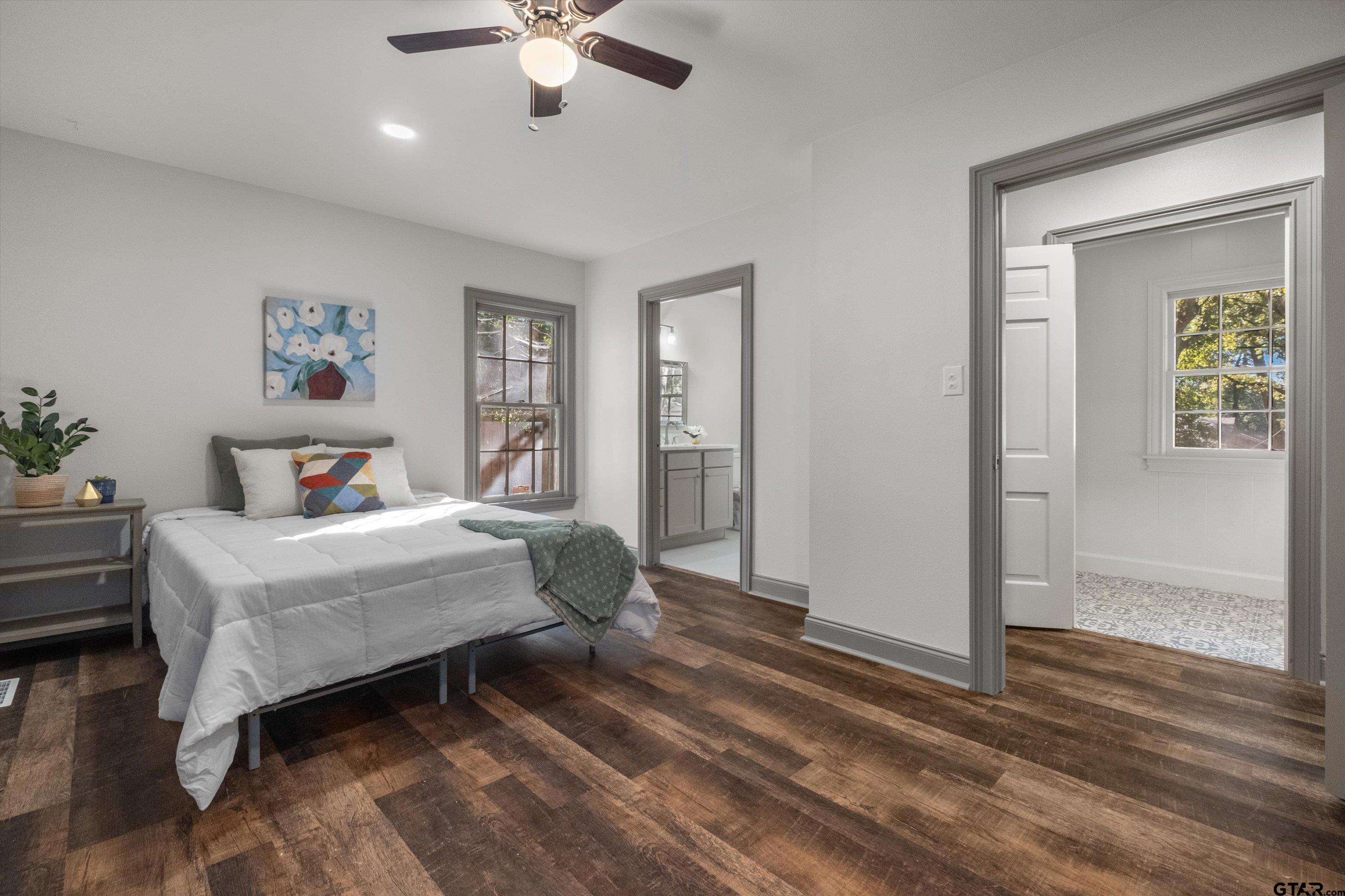 2126 McDonald Road Tyler, TX 75701 - Photo 18 of 26 a bedroom with a bed and a chandelier