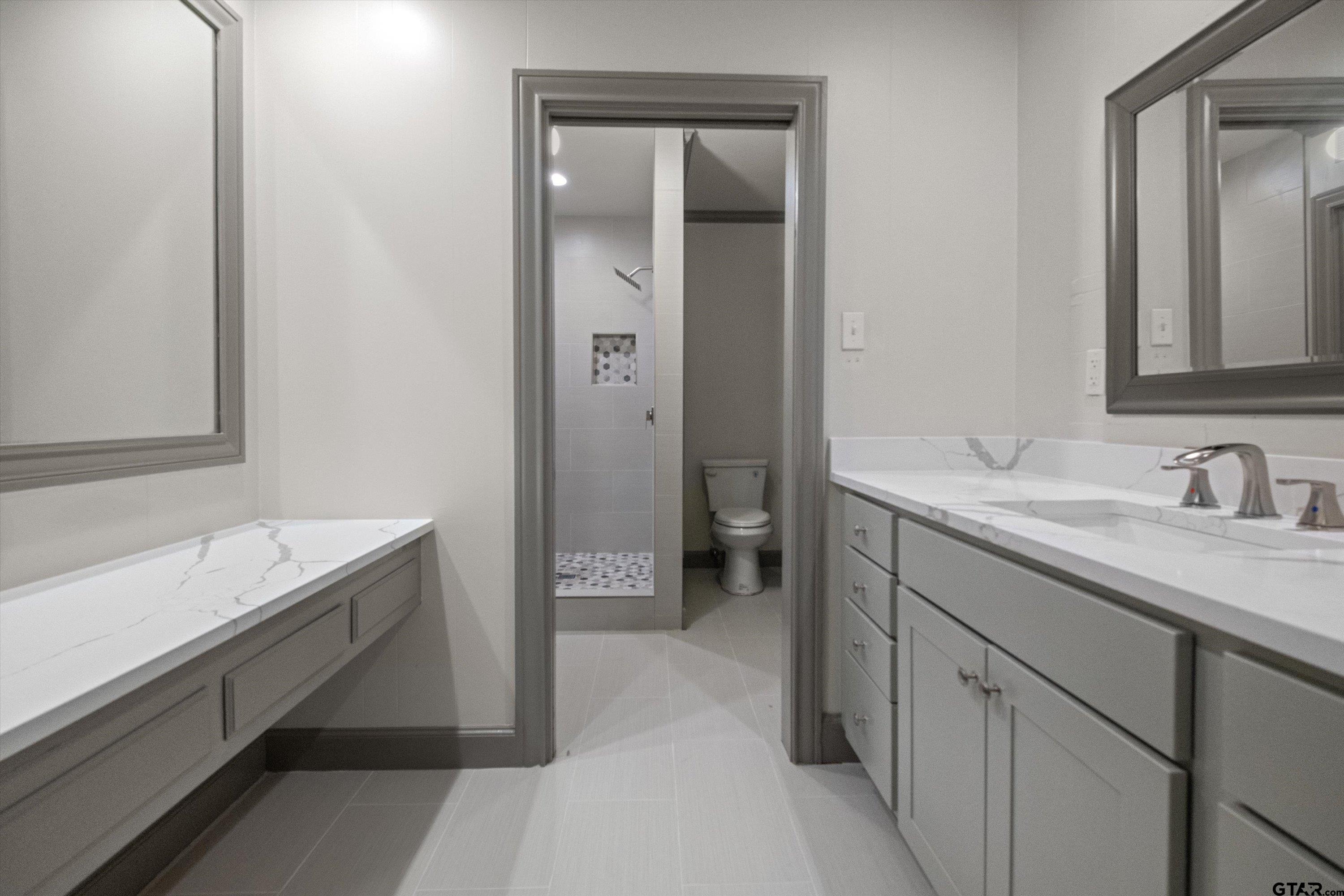 2126 McDonald Road Tyler, TX 75701 - Photo 19 of 26 a bathroom with a sink and a mirror