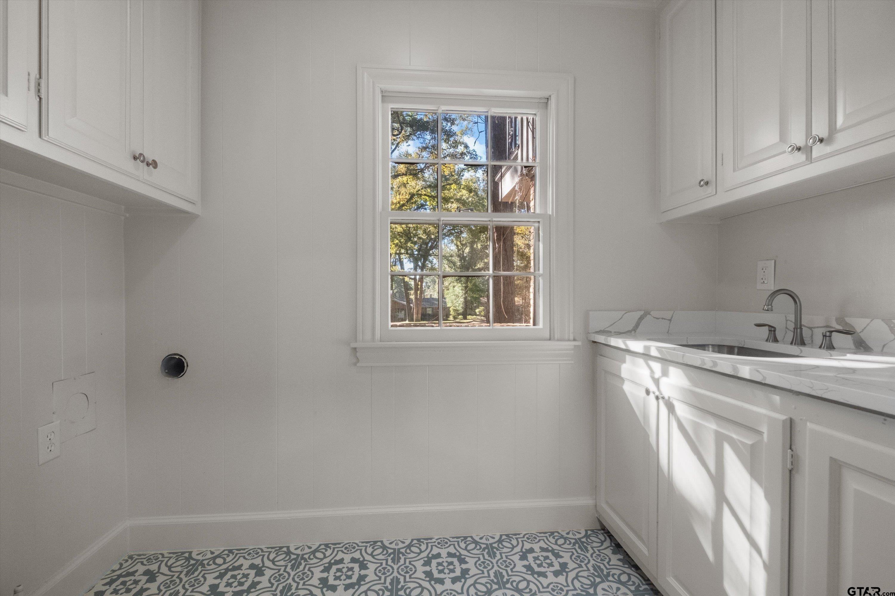 2126 McDonald Road Tyler, TX 75701 - Photo 23 of 26 a bathroom with a sink and a window
