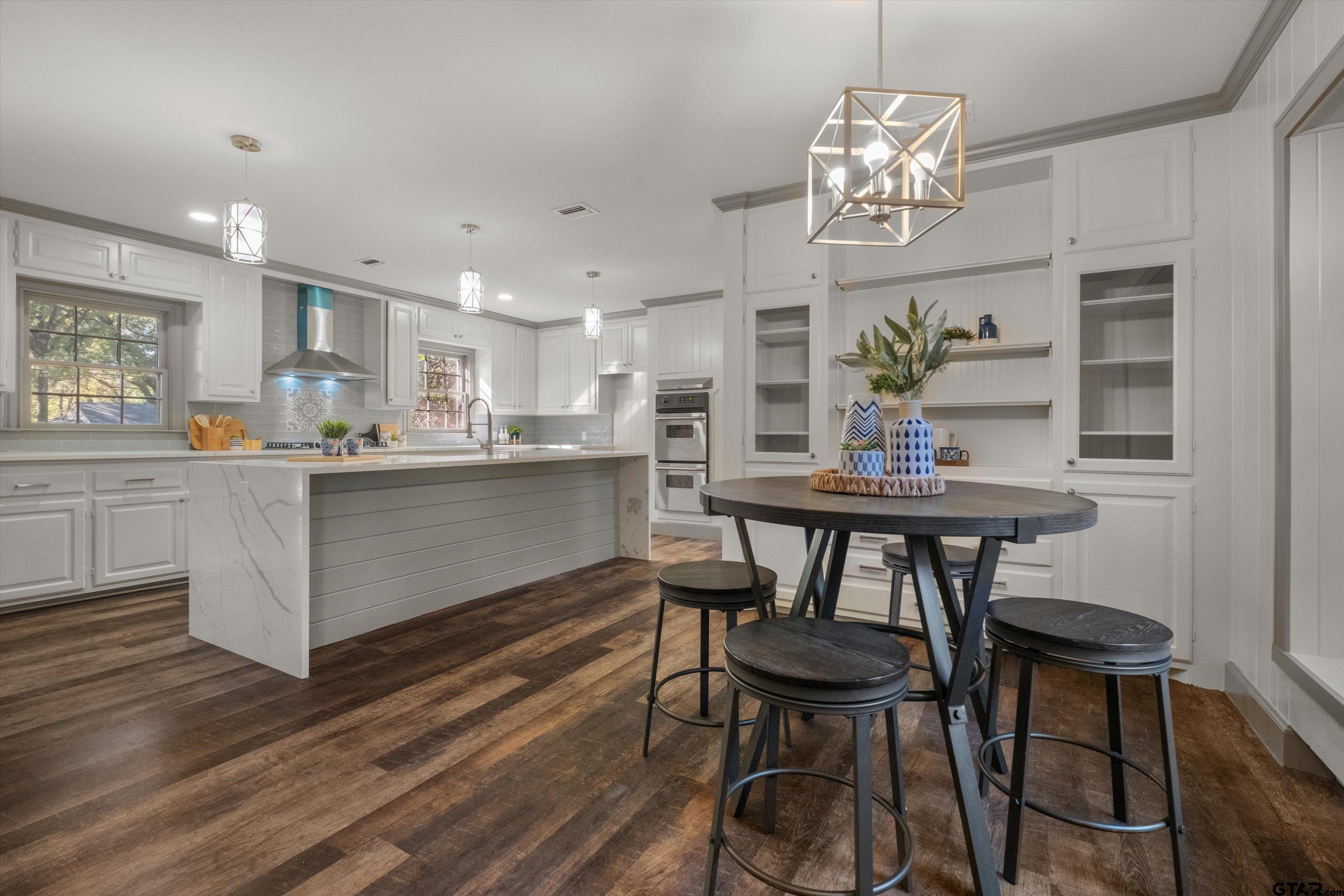 2126 McDonald Road Tyler, TX 75701 - Photo 9 of 26 a kitchen with kitchen island a dining table chairs cabinets and stainless steel appliances