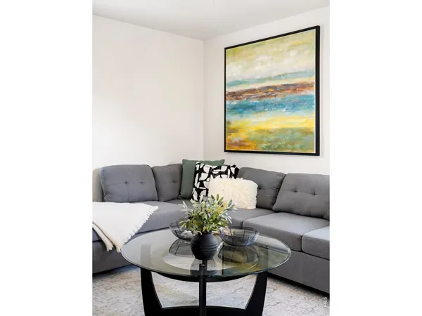 a living room with furniture and a large window