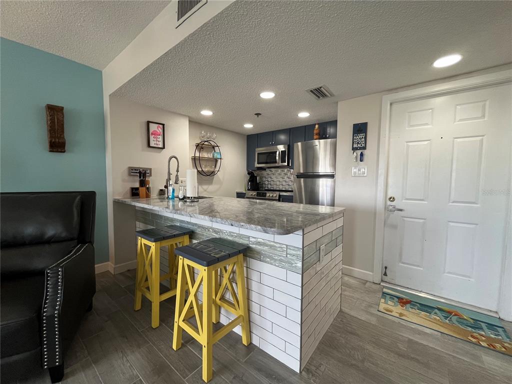 3160 Matecumbe Key Road, Unit 235 Punta Gorda, FL 33955 - Photo 3 of 15 a kitchen with kitchen island stainless steel appliances a sink and cabinets