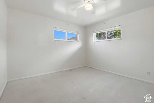 380 North 300 East Mapleton, UT 84664 - Photo 14 of 35 Wall-to-wall carpeting, white walls, two horizontal windows, and a ceiling fan with integrated lighting