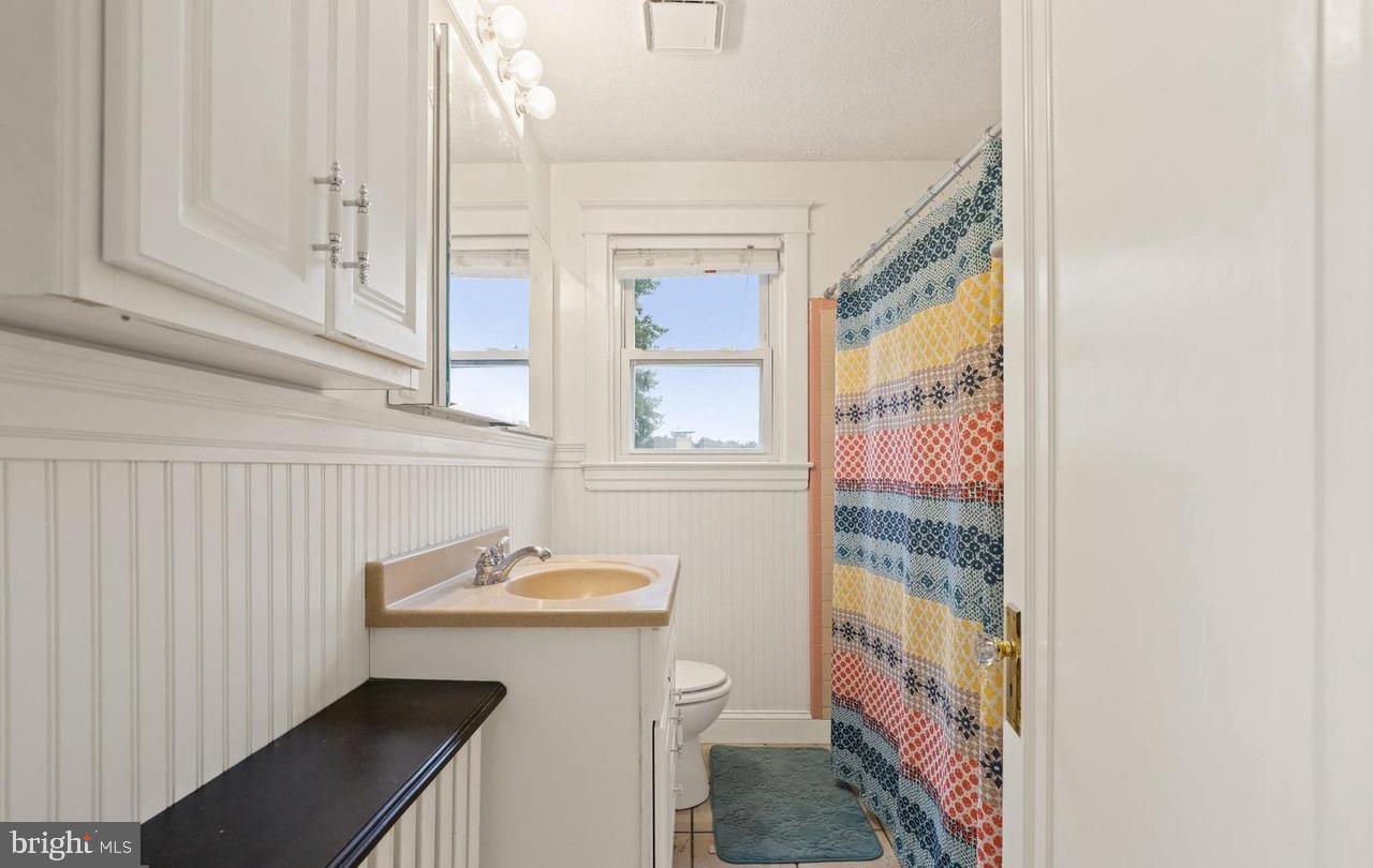 7844 St Thomas Drive Baltimore, MD 21236 - Photo 3 of 5 a bathroom with a sink a toilet and shower