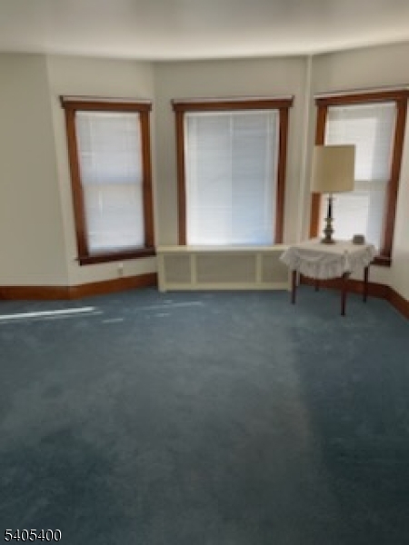 72 Baldwin Place, Unit 2 Bloomfield, NJ 07003 - Photo 2 of 9 a view of room with window and lounge chair