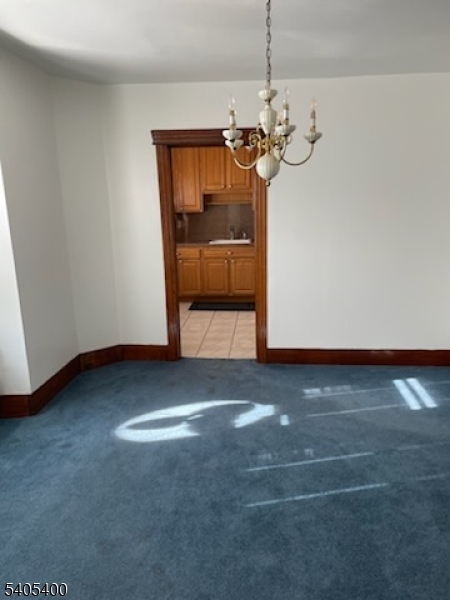 72 Baldwin Place, Unit 2 Bloomfield, NJ 07003 - Photo 3 of 9 a view of a room with a hanging light and kitchen