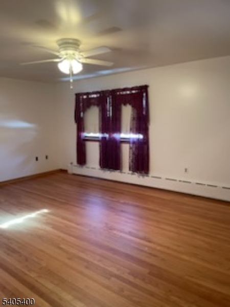 72 Baldwin Place, Unit 2 Bloomfield, NJ 07003 - Photo 5 of 9 a room with wooden floor
