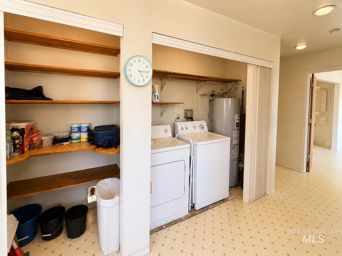 16434 Pride Lane Caldwell, ID 83607 - Photo 6 of 16 Dedicated laundry area featuring a washer and dryer, adjacent to built-in shelving