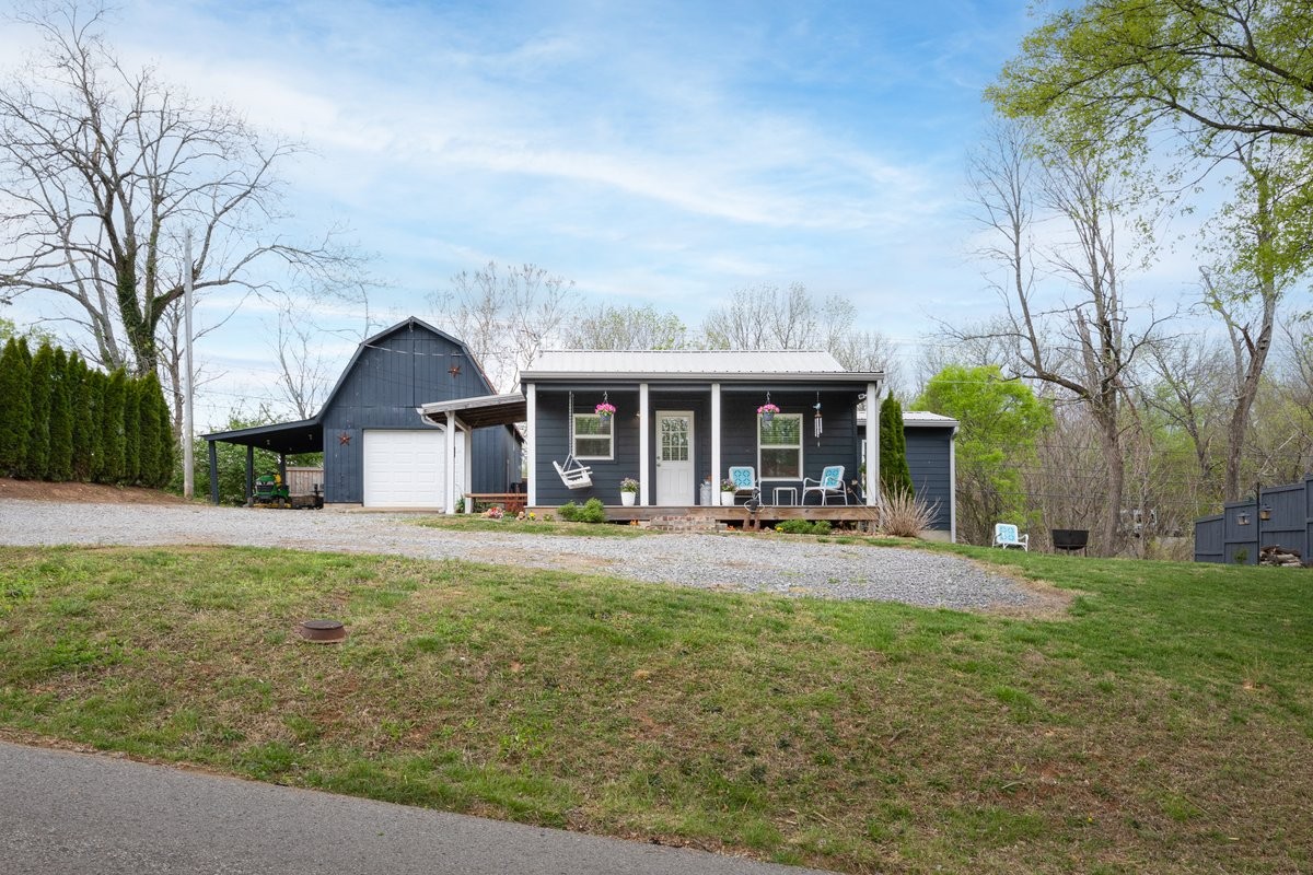 a front view of a house with yard patio and green space