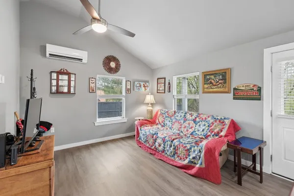 a living room with furniture and wooden floor