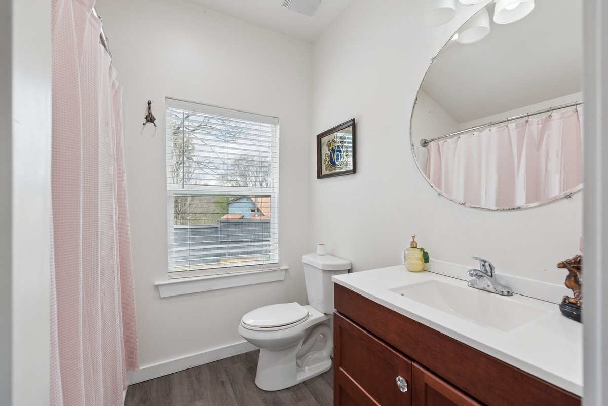 150 Crawford Hill Road Goodlettsville, TN 37072 - Photo 26 of 30 a bathroom with a toilet a sink a mirror and a window