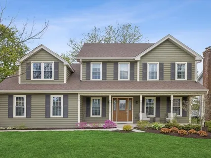 front view of brick house with a yard