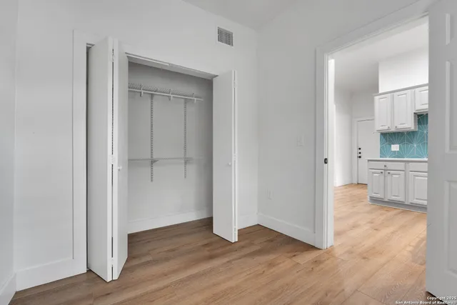 a view of a kitchen with wooden floor and a sink