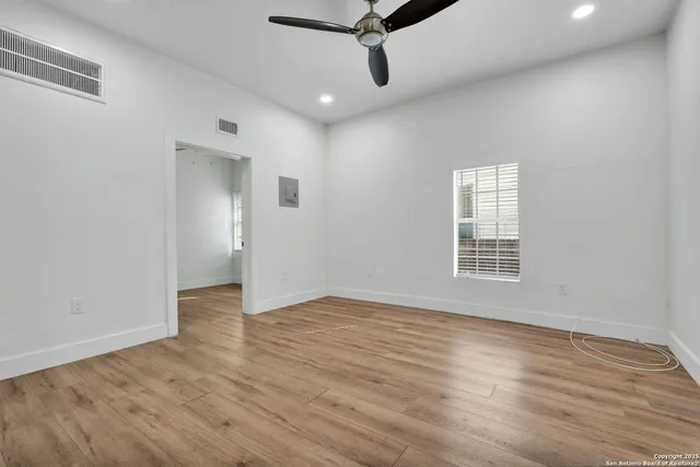 wooden floor in an empty room with a window