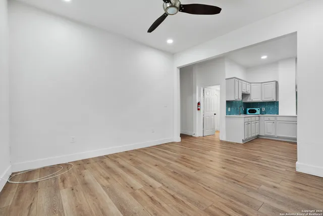 a view of a kitchen with a sink and a refrigerator