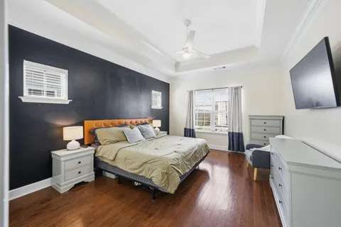 a bedroom with a bed and a flat screen tv