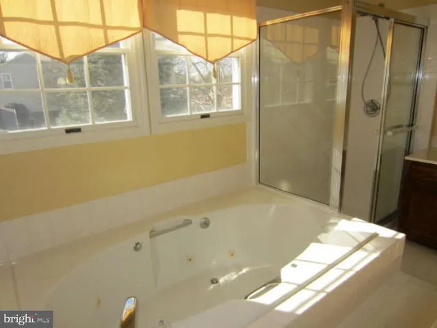 a bathroom with a bathtub and shower