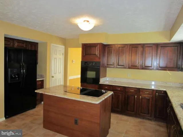 a kitchen with stainless steel appliances granite countertop a stove and a refrigerator