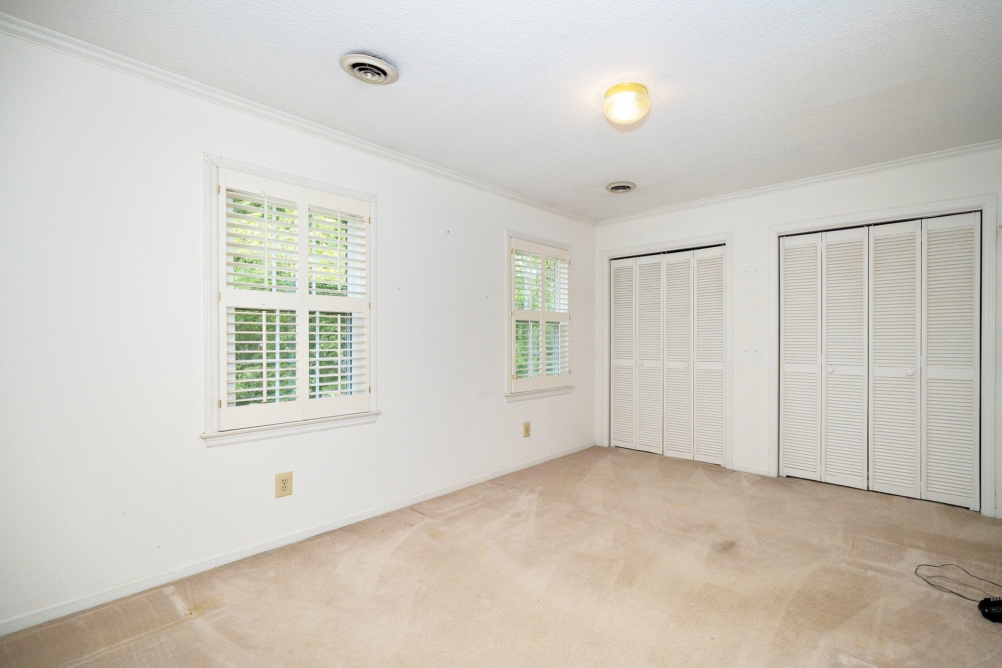 1512 Pony Run Road Raleigh, NC 27615 - Photo 23 of 39 Secondary Bedroom has Plantation Shutters, 2 Double Closets + a Third Deep Storage Closet. Secondary Bedroom