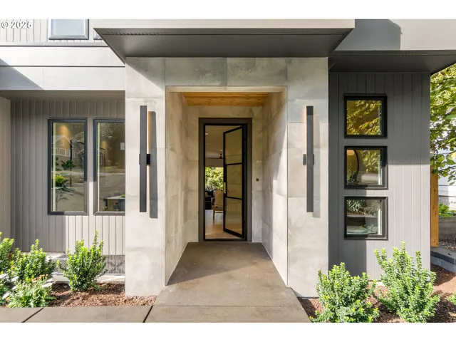 a view of a front door of the house and a yard