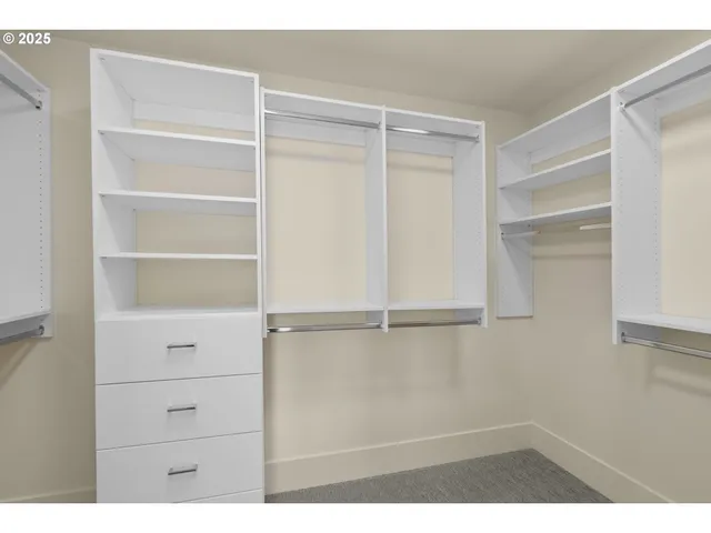 a view of walk in closet with empty racks