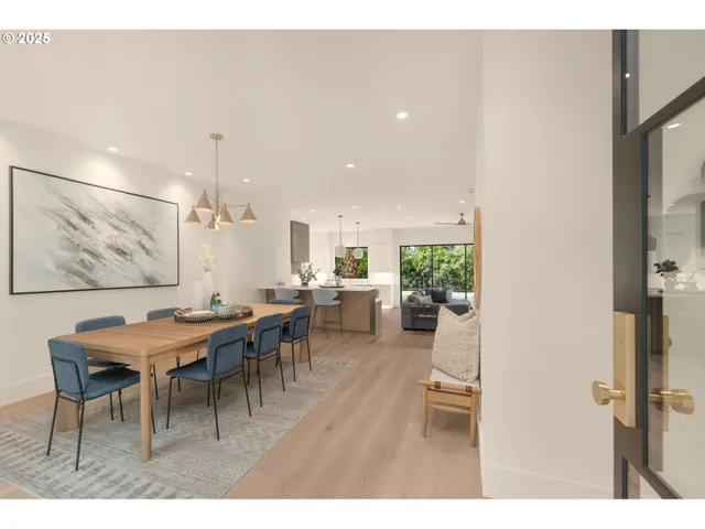 a living room with furniture a table and wooden floor