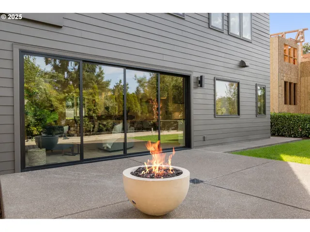 a view of brick house with potted plants