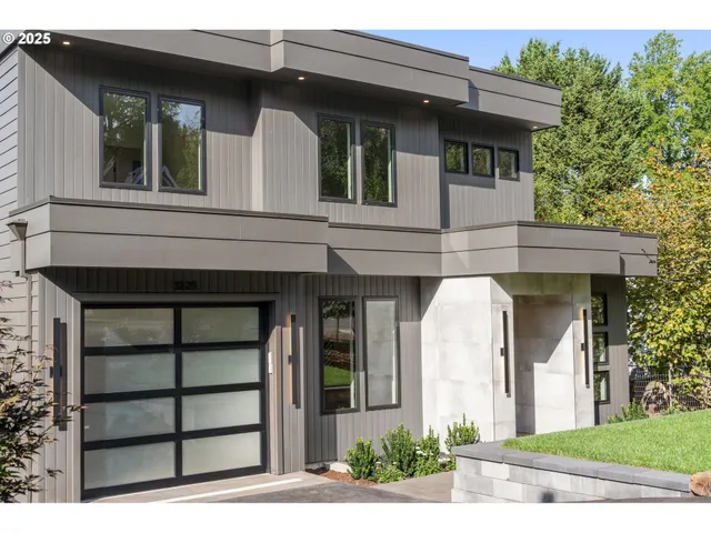 a view of a house with a plants and a tree