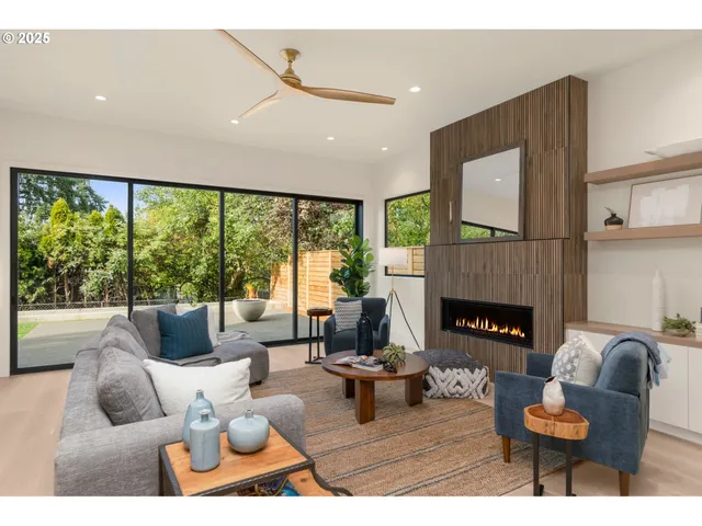a living room with furniture fireplace and a large window