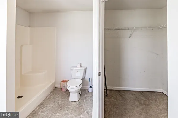 a bedroom with a bed and cabinets