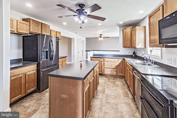 a kitchen with a stove sink and microwave