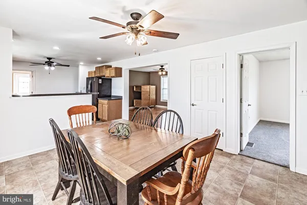 a view of a dining room with furniture and a chandelier