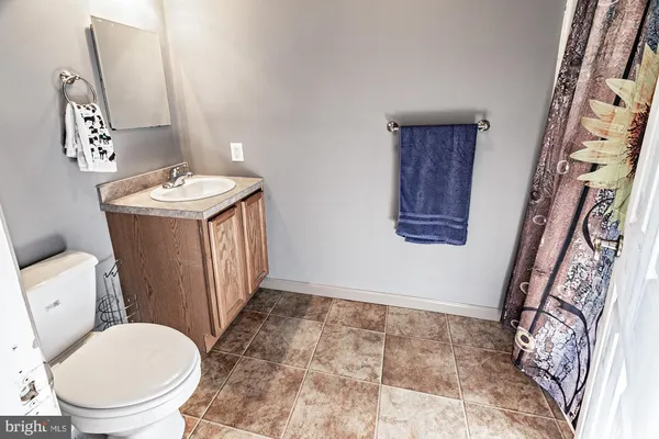 wooden floor in an empty room with a kitchen