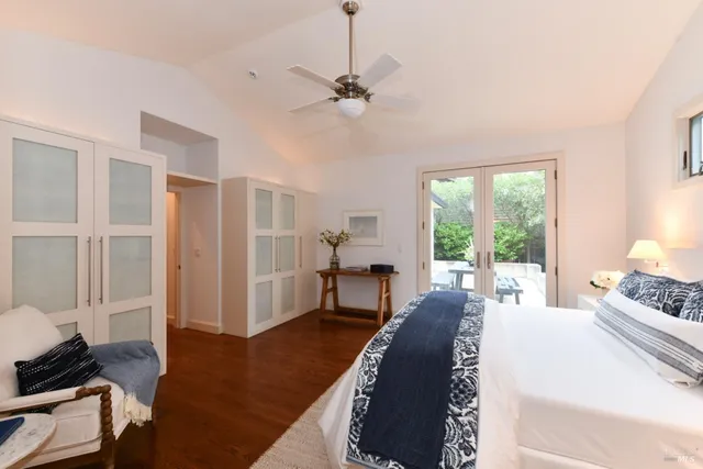 a spacious bedroom with a bed and a chandelier