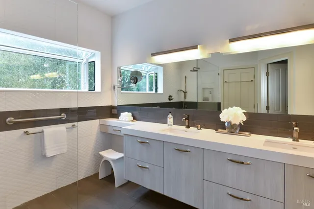 a bathroom with a double vanity sink and mirror