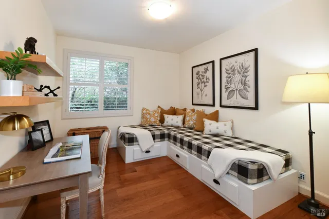 a view of a workspace with furniture and a window