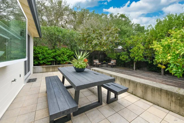 a view of backyard with seating area and green space
