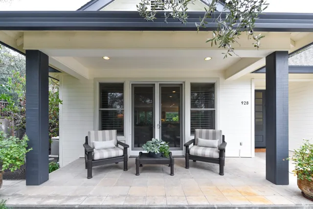 a building outdoor space with patio furniture and potted plants