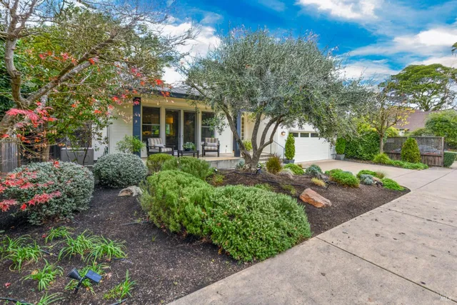 a front view of a house with garden
