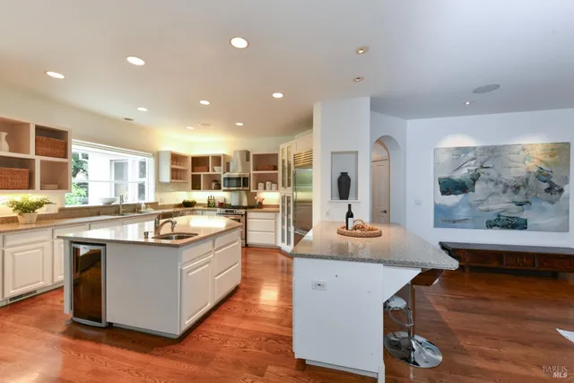 a large kitchen with kitchen island a sink and a stove