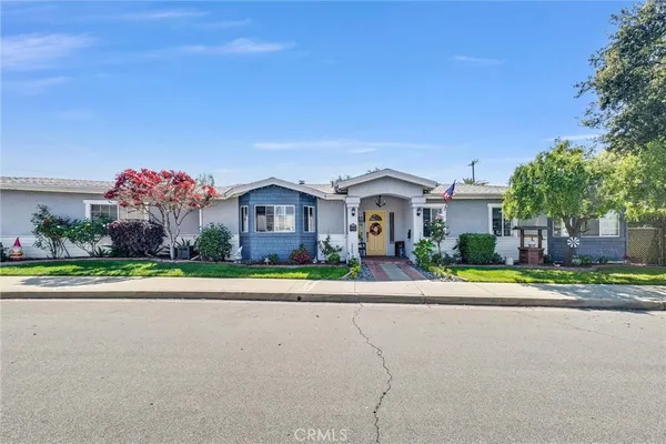 a front view of a house with a yard and a garage