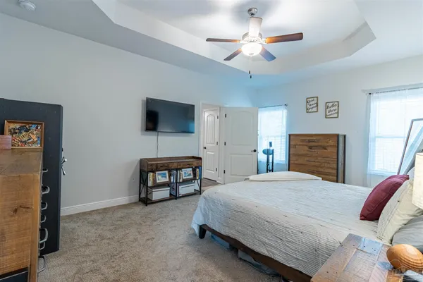a bedroom with a bed and a chandelier