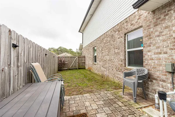 a backyard of a house with fire pit and outdoor seating
