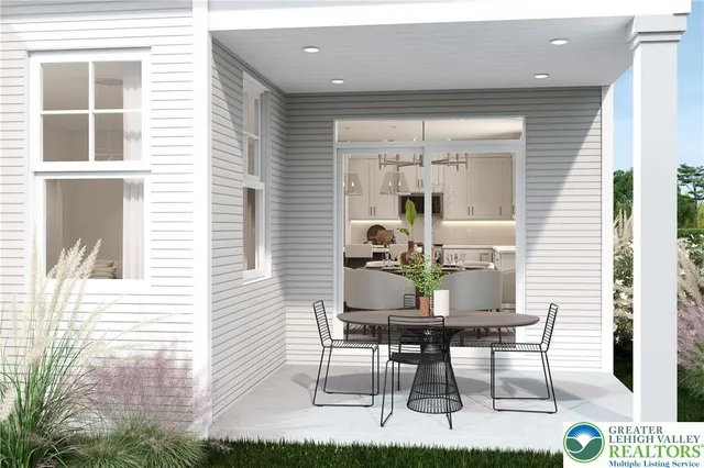 a view of a dining room with furniture and front door