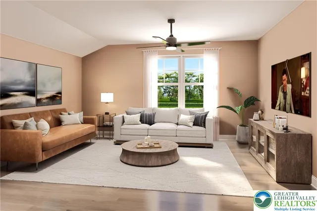 a living room with furniture a flat screen tv and a chandelier