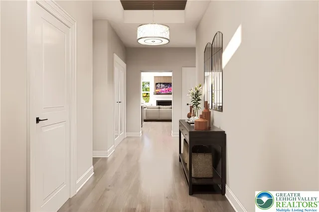 a view of a hallway with wooden floor and furniture