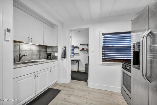 a kitchen with a refrigerator stove and sink