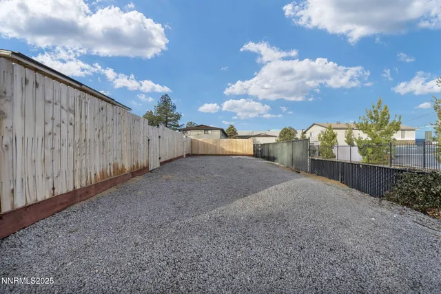 a view of a house with backyard and a tree